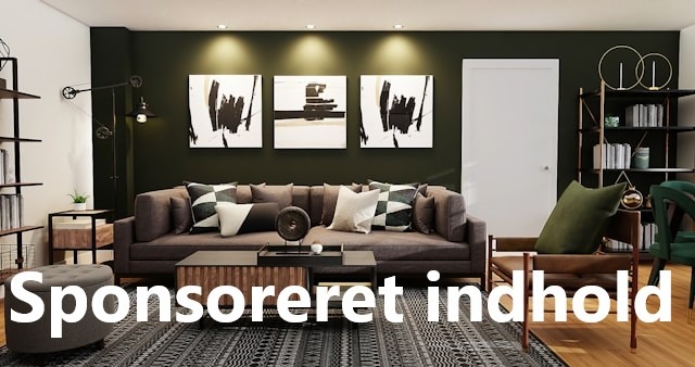 Stue med mange møbler, hvor en flot lædersofa er placeret centralt foran em mørk, grøn væg